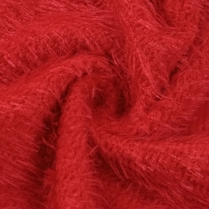 Macro shot of dark red plush faux fur texture with detailed woven fiber structure