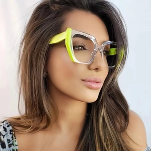 Close-up of cat-eye frames featuring trendy neon green and transparent color blocking design