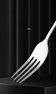 Detail of polished stainless steel fork tines with smooth edges and mirror finish