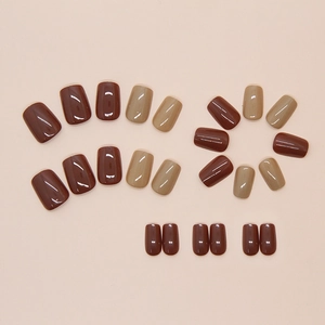 Mocha brown and tan square-oval press-on nails with a glossy finish on beige background