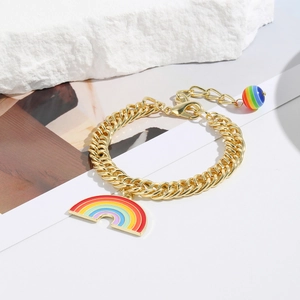 Detail of gold bracelet featuring a rainbow enamel semi-circle pendant and bead