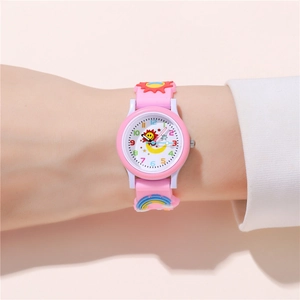 Detail of pink silicone watch band with 3D sun and rainbow for kids quartz watch