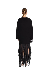 Rear view of black long-sleeve knit sweater and layered chiffon ruffle maxi skirt set
