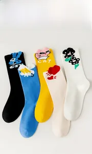 Detail of five pairs of colorful mid-calf cotton socks with cute cartoon animal patterns