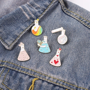 5-piece set of cartoon chemistry enamel pins with rainbow patterns on a denim jacket collar