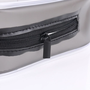 Waterproof clear PVC travel cosmetic bag with durable black zipper detail and smooth finish