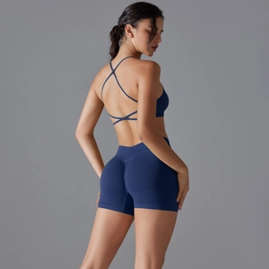 Detail of cross-back yoga bra and high-waist scrunch shorts in deep blue sport set