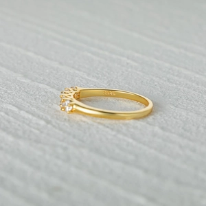 Detailed macro shot of a gold S925 sterling silver band with sparkling row of cubic zirconia
