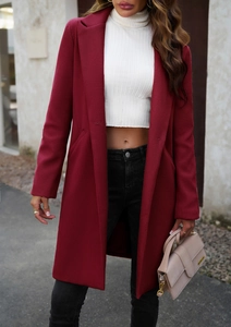 Street style shot of a burgundy wool coat with a classic notched lapel and slim-fit cut