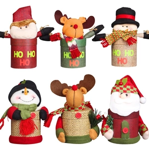 Christmas gift boxes with Santa and reindeer plush tops on woven candy jars