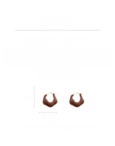 Detail view showing brown flocked irregular earrings, copper material, weighing 10.6 grams