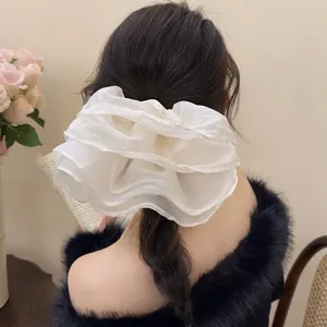 Oversized white ruffled tulle scrunchie with layered design for elegant ponytails