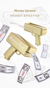 Golden handheld electric money gun toy with flying fake banknotes on a bright background