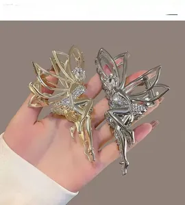 Detail of angel wing hair claws with rhinestones in gold and silver metal finishes