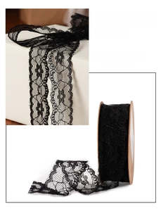 Detailed view of 25mm black lace ribbon with hollow floral pattern for gift wrapping