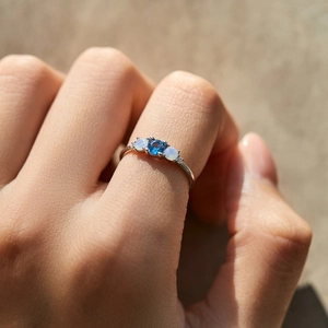 Elegant S925 sterling silver ring with blue crystal and white opal stones on hand