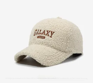 Detail view of Galaxy 1990 embroidery on soft cream faux shearling baseball cap