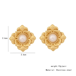 Detailed view of gold shell flower earrings in stainless steel with white pearls