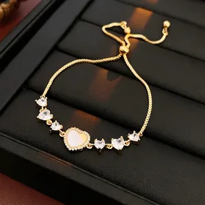 Adjustable gold plated heart bracelet with zircon stones and mother of pearl inlay