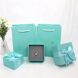 Elegant jewelry gift box set in Tiffany blue with ribbons and matching paper bags