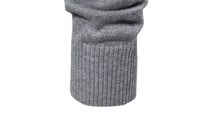Detailed macro view of grey knit cardigan ribbed cuffs with high-quality yarn texture