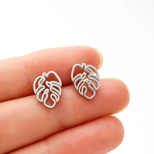 Detail of silver monstera leaf earring featuring intricate brushed hollow-out metalwork