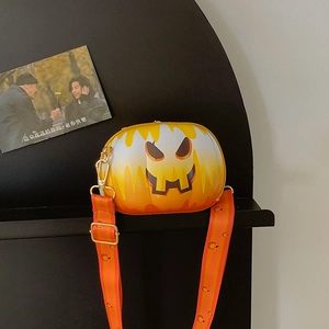Macro shot of Halloween pumpkin crossbody bag with metal gold hooks and adjustable strap