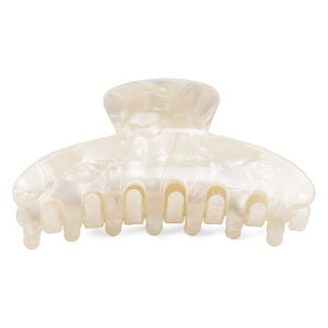 Macro view of a large acetate shark hair claw clip in beige marble pattern with smooth teeth
