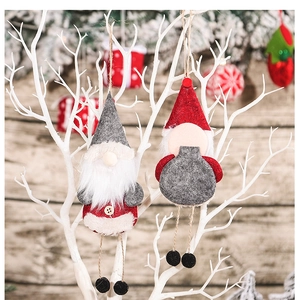 Close-up of Nordic Christmas gnomes with faux fur beards and wooden buttons on branches