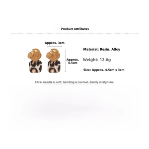 Detail view of acrylic leopard print square earrings with textured gold-tone metal