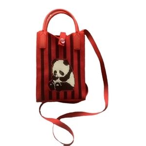 Handmade knitted panda handbag with red stripes and shoulder strap for casual wear