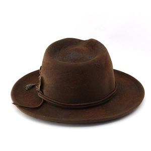 Detailed macro view of vintage dark brown fedora hat with distressed wool felt and cord