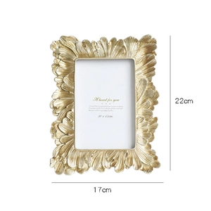 Golden resin frame with leaf relief patterns showing dimensions 17x22cm and 10x15cm