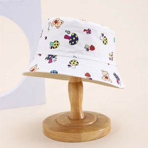 Detail of white kids sun hat with colorful mushroom and cartoon bear print