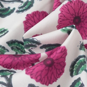 Détail du tissu lisse avec imprimé floral de fleurs roses et de feuilles vertes