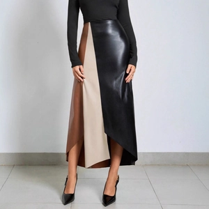 Detail of color-block high-waisted PU leather skirt featuring black and beige panels