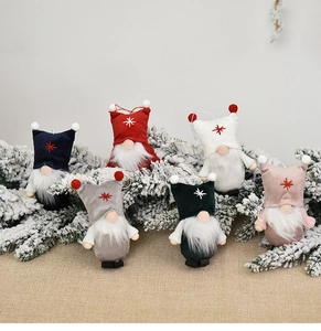 Detailed close-up of six plush Christmas gnomes hanging in various colors for tree decor