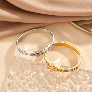 Macro shot of buckle bangles with crystal pavé in gold and silver plating