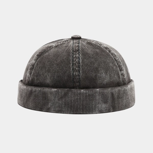 Close-up of vintage dark grey corduroy fabric texture and stitching on the Miki Hat
