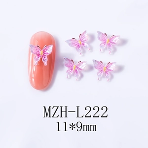 Detailed view of 3D resin butterfly nail charms in gradient pink with shimmer effects