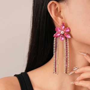Close-up of elegant rose pink floral tassel earrings with rhinestones on model side profile