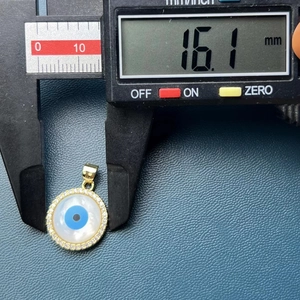 Detail view of gold Evil Eye pendant with blue zircon center measuring 16.1mm in diameter