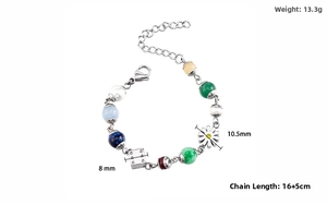 Macro shot of stainless steel bracelet with daisy pendant, dice charm, and colorful stones