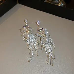 Detail of elegant tassel earrings with pearls, zircons, and sparkling crystal fringes