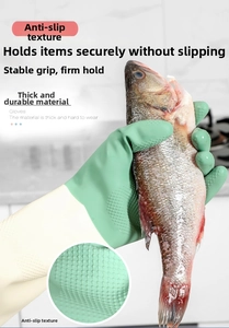 Close-up of non-slip texture on thick rubber cleaning gloves holding a fresh fish