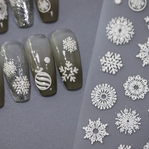 3D embossed Christmas nail stickers featuring white snowflakes and winter patterns