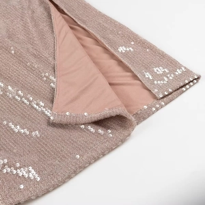 Macro detail of sparkling pink sequins on beige lining of this elegant party dress