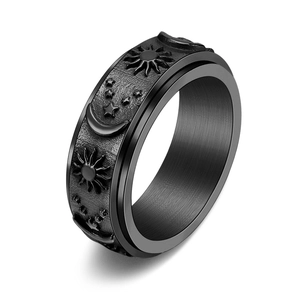 Detail of black titanium steel spinning ring with sun moon and star engravings
