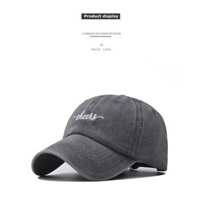 Close-up of cheers embroidery on dark gray washed cotton baseball cap texture