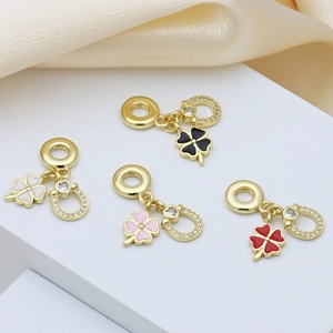 Golden four-leaf clover and horseshoe charms on satin base for jewelry making